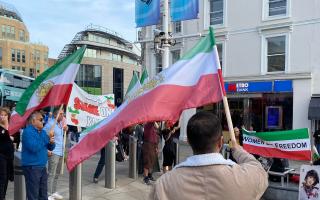 Protesters waved the old Iranian flag used before the current regime took power in 1979