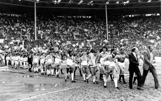Jimmy Melia leads Brighton and Hove Albion out against Ron Atkinson's Manchester United for the 1983 FA Cup Final at Wembley against a backdrop of the Albion fans