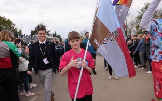 Syd Shayler carrying a flag ahead of the Harlequins team on the way to Twickenham