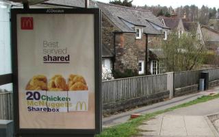 Fast food adverts on bus shelters will be banned from 2024 (stock image)