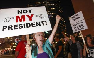 Faith Attaguile, from Encinitas, yells chants with other protesters against president-elect Donald Trump as they on the corner of Broadway and Front Street in downtown San Diego on Wednesday.  Picture: Hayne Palmour IV/San Diego Union-Tribune/Zuma Press