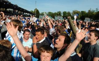 INVASION: Hundreds of fans take to the pitch to celebrate Saturday's win