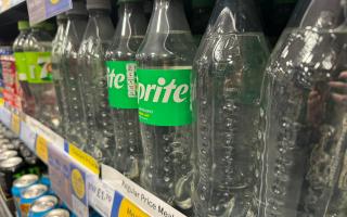 Labelled and label-less bottles of Sprite in Tesco Express in Western Road, Brighton