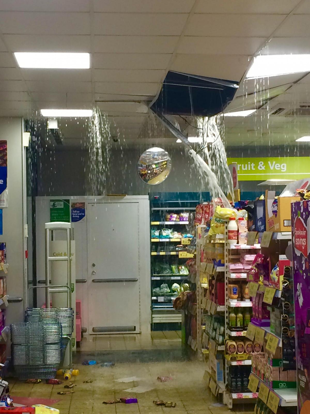The ceiling of the Tesco Express in Jubilee Street in Brighton collapses as rainwater pours through. Picture by Cat Smith