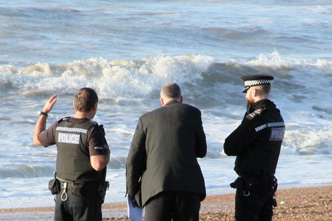 Police officers on Shoreham beach this morning
