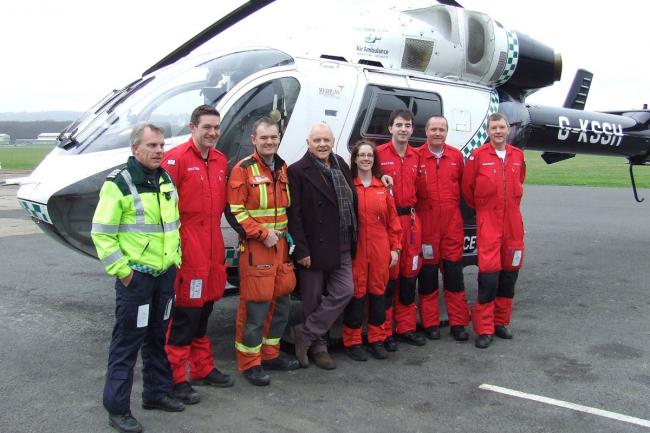 Sir Anthony Hopkins, centre, with members of the Kent, Sussex and Surrey Air Ambulance based at Redhill Aerodrome