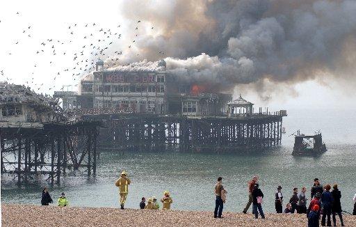 As the fire takes hold of the pier, flocks of birds fled the structure