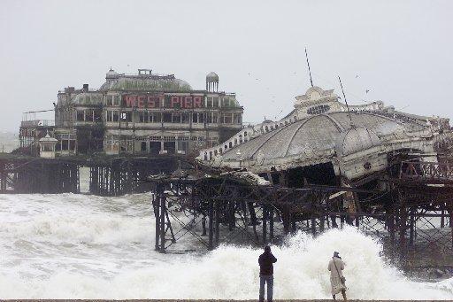 The West Pier tilts over at a severe angle in this picture taken in January 2003. It has been disappearing into the sea since the storms at the end of 2002.
